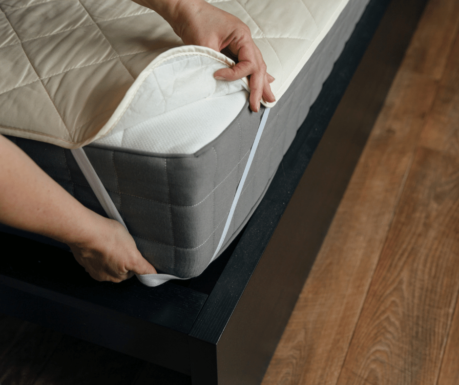 Image of mattress topper being placed onto bed.